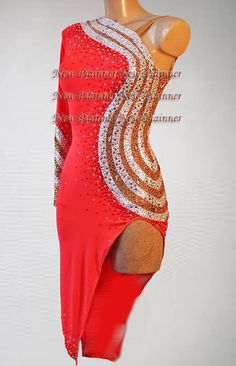 a woman's red and gold dress on display in front of a white wall