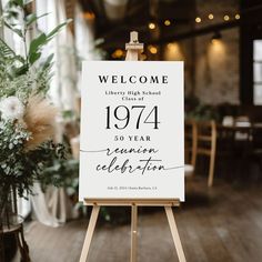 a welcome sign in front of a wooden easel