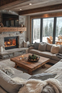 a living room filled with furniture and a fire place in front of a large window