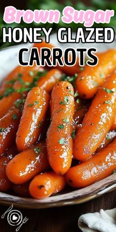 honey glazed carrots in a white bowl on a wooden table with the words brown sugar honey glazed carrots