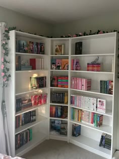 a white book shelf filled with lots of books