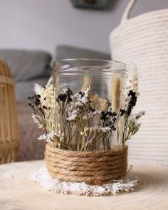 some dried flowers are in a glass jar