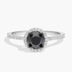 a black and white diamond ring with diamonds on the sides, set in 18k white gold