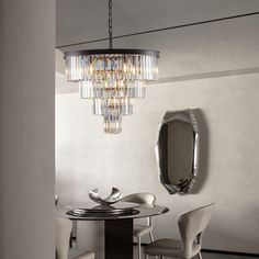 a modern dining room with white chairs and a chandelier hanging from the ceiling