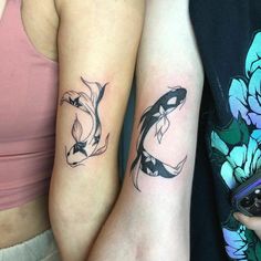 two people with tattoos on their arms and one has a koi fish in it