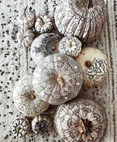 an arrangement of decorative ornaments on a white tablecloth with black and white laces