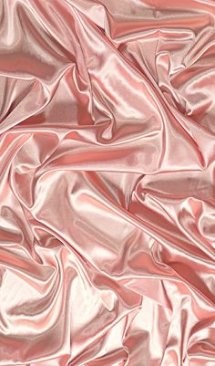 an image of pink satin fabric textured with metallic flecks and folds on the surface