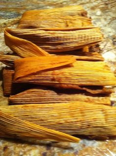 three pieces of tamales sitting on top of a counter