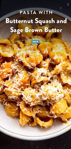 pasta with butternut squash and sage brown butter in a white bowl on a black table