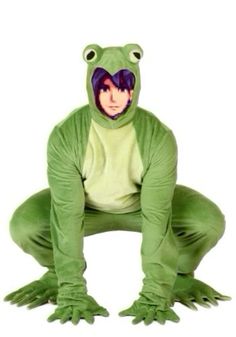 a person in a frog costume is squatting down with his legs crossed and eyes wide open