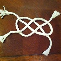 a piece of white rope on top of a wooden table