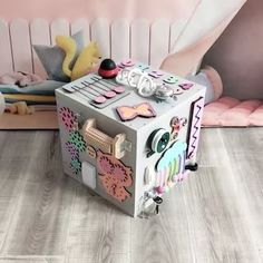 a small toy chest sitting on top of a wooden floor