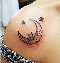 a woman with a crescent and stars tattoo on her shoulder