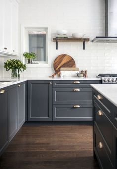 the instagram page shows an image of a kitchen with gray cabinets and white walls