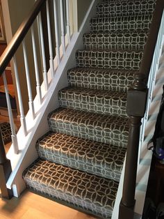 a set of stairs with carpet on the bottom and handrails to the top