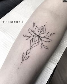 a black and white photo of a flower on the arm