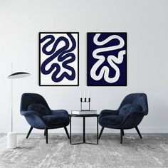 two blue chairs sitting next to each other on top of a carpeted room floor