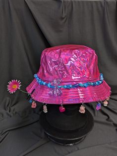 -hat color - pink -bead color -blue -charm color - blue and pink -unisex adult size -inner circumference - 22.5in -crown dip - 3in -brim - 2.25in -NOT machine washable -Perfect for raves and outdoor festivals! Shipping within the US USPS First Class Package 3-9 days USPS Priority Mail 1-5 days USPS Priority Mail Express 1-3 days Shipping International  USPS First Class Mail International  -Varies- USPS Priority Mail International 6-14 days USPS Priority Mail Express International 3-9 days Shipping times are estimated, NOT GUARENTEED.  +International buyers are responsible for all import fees+ +Orders of $50+ may require signature confirmation upon delivery+ Cheap Multicolor Festival Hats, Luxury Blue Festival Hat, Pink Adjustable Wide Brim Bucket Hat, Trendy Pink Brimmed Mini Hats, Fun Pink Hat, One Size, Pink Mini Hat For Festivals, Pink Adjustable Bucket Hat With Short Brim, Pink Wide Brim Hat One Size, Fun Pink Adjustable Bucket Hat