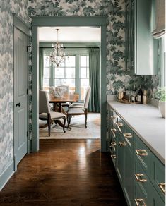 a dining room and kitchen with blue wallpaper