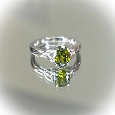 Top Of Ring Height: 8.0mm Top Of Ring Width: 6.0mm Band Width: 2.7mm Shank Width: 1.6mm Stone Material: Peridot Cubic Zirconia Center Stone Size: 8.0mm X 6.0mm Stone Shape: Oval Center Stone Carat Weight: 1.21 Ct Stone Setting: Prong Metal: 925 Sterling Silver Plating: Rhodium Plated Finish: High Polish Alt Rooms, Heart Knot Ring, Peridot Engagement Ring, Peridot Engagement Rings, Dainty Wedding Ring, Big Stone Ring, Dream Future, Unique Rings Vintage, Stone Material