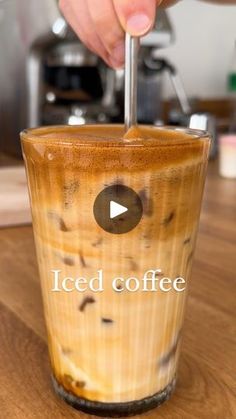 a person is pouring iced coffee into a cup with the words iced coffee on it