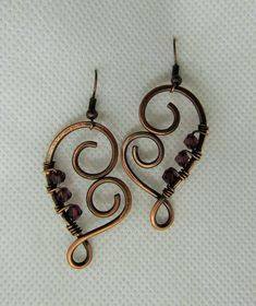 This listing is for one pair wire wrapped Heart Amethyst Crystal in Copper Earrings. Please read all listings carefully and if you have questions, address them to me and I will answer quickly. I thank you for shopping with Sparrow Song. New Pendant by Sparrow Song: Heart Shaped Copper and Crystal Earrings, measures 4.5 by 2.5 cms. Please inquire for your own tailor custom earrings with a choice of metal, crystal or stone. See what my customers are saying about my jewelry https://www.etsy.com/you Wire Wrapped Metal Earrings For Crafting, Heart-shaped Wire Wrapped Earrings For Gift, Wrapping Crystals, Wire Wrapped Heart, Wire Wrap Earrings, Wire Ideas, Wire Jewelry Earrings, Wire Jewelry Patterns, Wire Craft