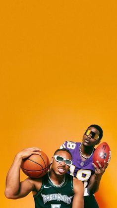 two young men holding basketballs in front of an orange background, one is wearing sunglasses and the other has a football