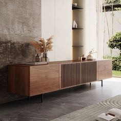 a living room with an entertainment center and bookshelf next to it on the floor