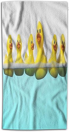 five rubber ducks lined up in a row on top of a blue towel with white background