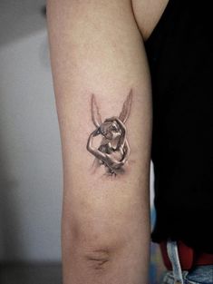 a woman's arm with a tattoo on it that has an image of a rabbit