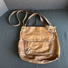 Elevate your everyday style with this stunning Fossil crossbody handbag. Crafted with distressed leather and gold hardware, this bag boasts a bohemian theme that is perfect for travel or casual occasions. The bag features a zip and snap closure, with two outside pockets and three inside pockets for ample storage space. The crossbody strap is made of leather and has a drop of 25 inches, making it comfortable to wear for extended periods. The bag is accented with studded details, stitching, and a strap accent, adding a touch of elegance to the overall design. The bag also comes with a bag charm and features folding capabilities for easy storage. Get ready to turn heads with this Fossil crossbody handbag, perfect for any fashion-forward woman. Brown Crossbody Bag Fossil, Bohemian Theme, Reno Nv, Top Handle Bags, Distressed Leather, Easy Storage, Everyday Style, Crossbody Strap, A Bag