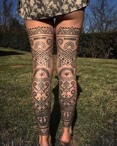 a woman's legs with tattoos on them