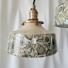 two hanging lights with floral designs on them