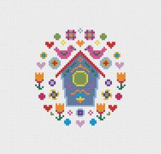 a cross stitch pattern with a birdhouse in the center and flowers around it on a white background