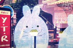 an advertisement for a restaurant in the window of a store with bunny characters on it