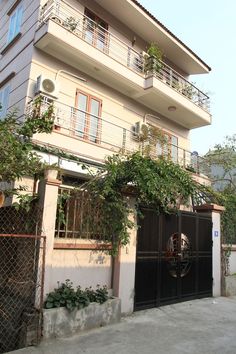 an apartment building with plants growing on the balconies