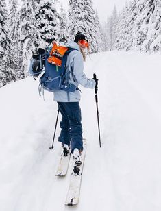 a man riding skis down a snow covered slope