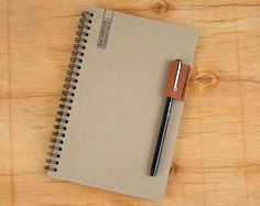 a notebook with a pen sitting on top of it