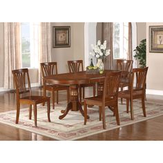 a dining room table and chairs with a rug on the floor