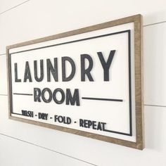 the laundry room sign is hanging on the wall