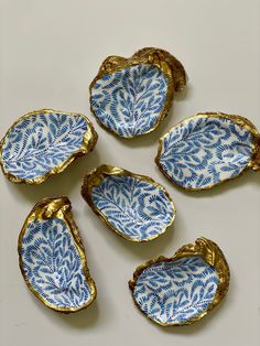 four blue and white dishes sitting on top of each other