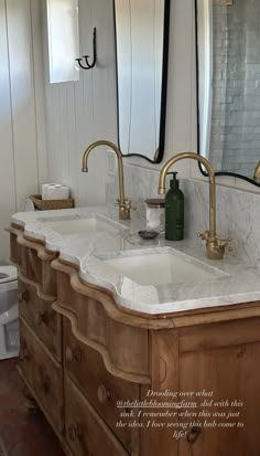 a bathroom with two sinks and mirrors on the wall