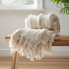 a blanket sitting on top of a wooden bench