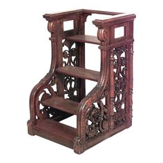 an ornate wooden shelf with carved carvings on the front and sides, holding two shelves