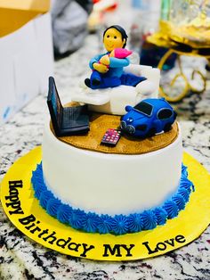 a birthday cake with a car and laptop on it