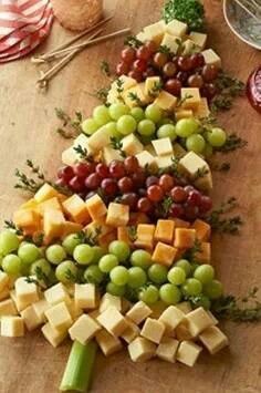 a christmas tree made out of cheese and grapes