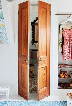 an open closet with clothes hanging on the wall