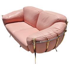 a pink leather chair with gold metal legs