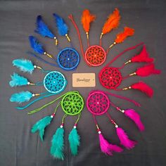 there are many different colored feathers arranged in a circle with a name tag on it