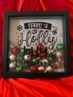 a framed christmas ornament with the words have a holly jolly christmas on it